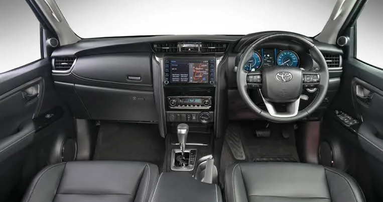 The cabin of a Toyota Fortuner, showing the dashboard, touchscreen and right-hand-drive steering wheel
